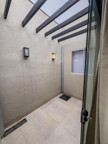 an empty room with a door and a window at Halmá Homes in Bonito