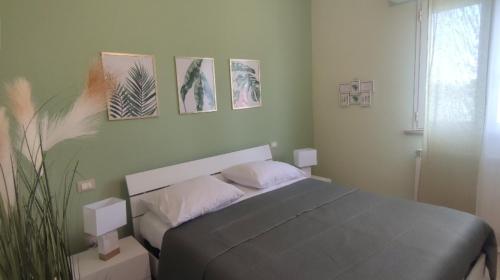 a bedroom with a bed and some pictures on the wall at Casa vacanza - Villa Dalila in Silvi Paese