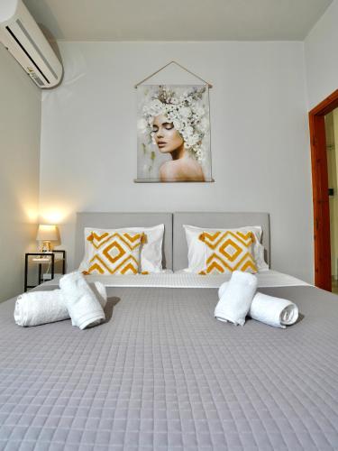 a bedroom with a large bed with two pillows at Panos Apartment in Kontokali