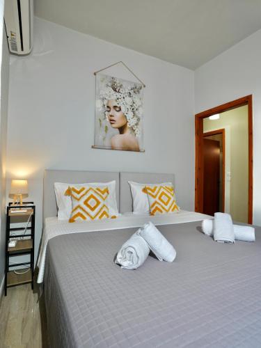 a bedroom with a large bed with towels on it at Panos Apartment in Kontokali
