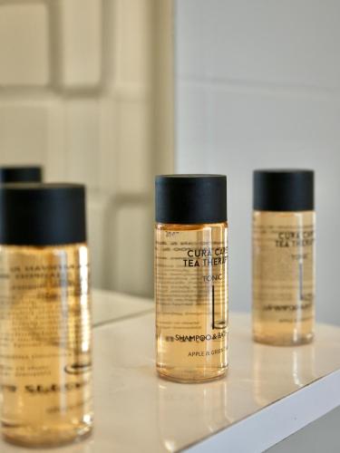 three bottles of essential oils sitting on a counter at Panos Apartment in Kontokali