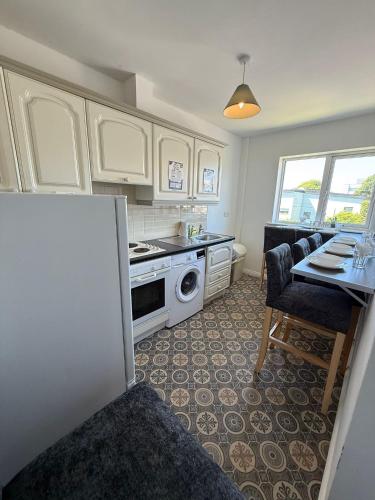 a kitchen with a sink and a stove top oven at Newcastle Townhouse in Galway