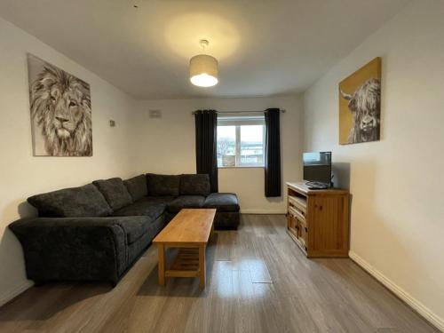 a living room with a couch and a table at Newcastle Townhouse in Galway