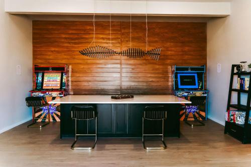 a kitchen with a counter and two bar stools at Stardust Big Bend Luxury A-Frame#10 with a fab view in Terlingua