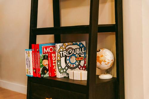 a book shelf with books and a globe on it at Stardust Big Bend Luxury A-Frame#10 with a fab view in Terlingua
