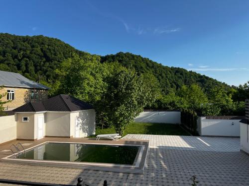 a swimming pool on the roof of a house at Vəndam villas in Vǝndam