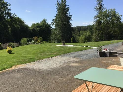 a picnic table on the side of a gravel road at Maison à la campagne, proche de Guingamp in Ploumagoar