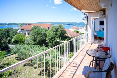 a balcony with a table and a view of the water at Villa MAR in Orebić