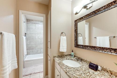 a bathroom with a sink and a mirror at Balcony, Walk to Hospital Condo in San Antonio in San Antonio