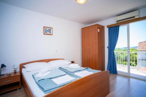 a bedroom with a bed and a large window at Villa MAR in Orebić
