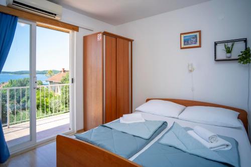 a bedroom with a bed and a large window at Villa MAR in Orebić