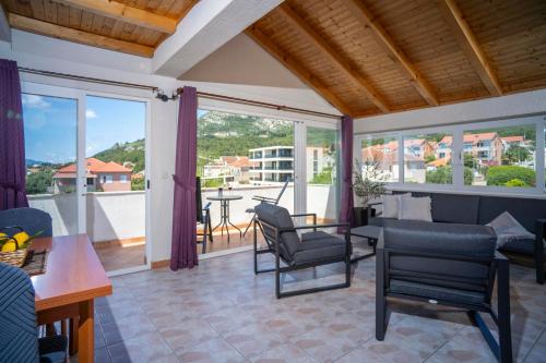 a living room with a couch and a table and chairs at Villa MAR in Orebić