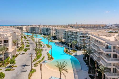 an aerial view of a resort with a pool and palm trees at Marassi marina 2 in El Alamein