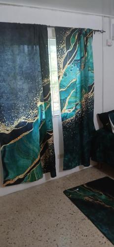 a room with a painting on the wall at Entire 3 bedroom house in St Thomas, Jamaica in Port Morant