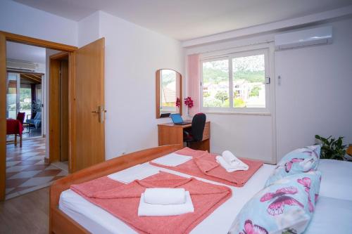 a bedroom with a bed with two towels on it at Villa MAR in Orebić