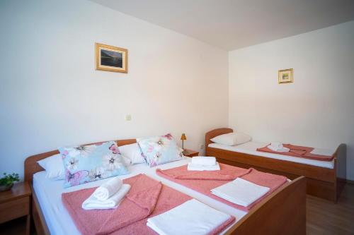a bedroom with two beds with towels on them at Villa MAR in Orebić