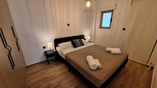 a bedroom with a bed with two towels on it at Vip Panoramic view in Athens