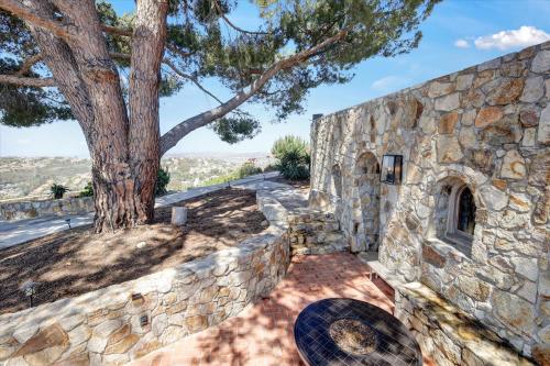 a stone wall with a tree behind it at Casa Grotto in San Marcos