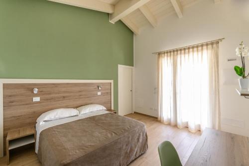 a bedroom with a bed and a large window at Terra Fina in Savio di Ravenna