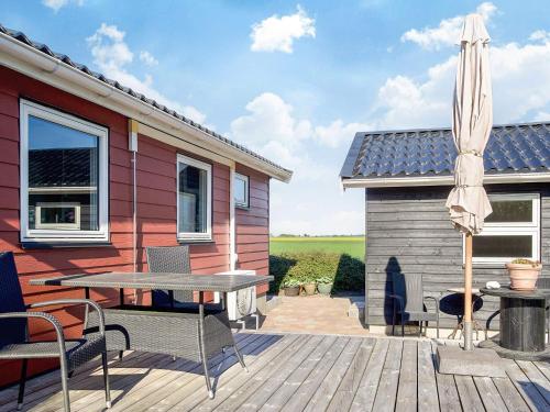 a patio with a table and an umbrella at 6 person holiday home in Slagelse in Slagelse