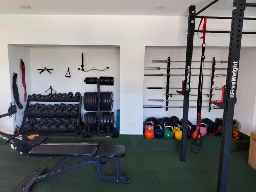 a gym with lots of equipment in a room at La casita de Isabel in Montecorto