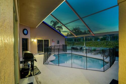 a house with a swimming pool with glass walls at Themed house with private Game Room and Pool in Loughman
