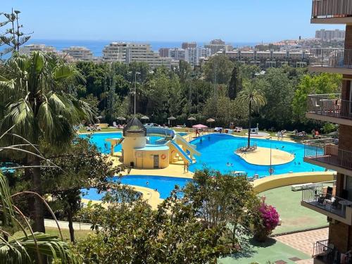 a view of the pool at a water park at Panoramic Views Cozy Apt Benalmádena Center in Benalmádena