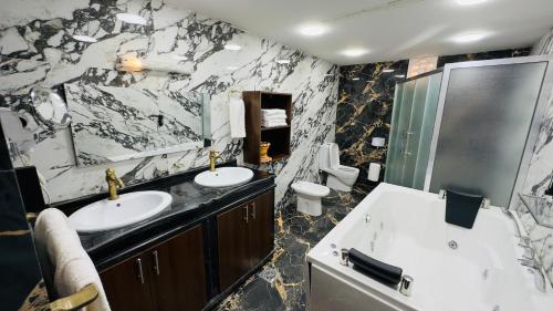 a black and white bathroom with two sinks and a shower at Rum rose luxury camp in Wadi Rum