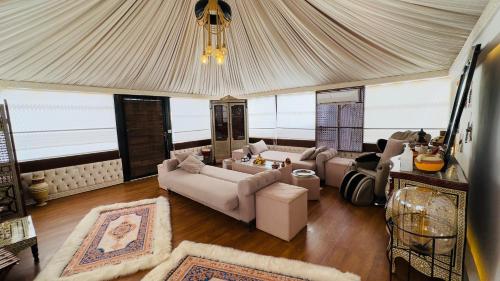 a living room with couches and a tent at Rum rose luxury camp in Wadi Rum