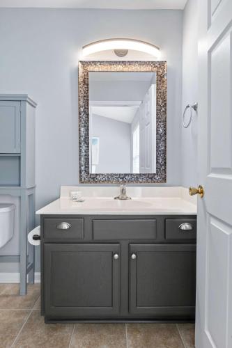 a bathroom with a sink and a mirror at Blue Belle - Across from Pool near Credit One in Charleston