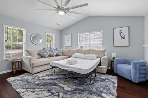 a living room with a couch and a table at Blue Belle - Across from Pool near Credit One in Charleston