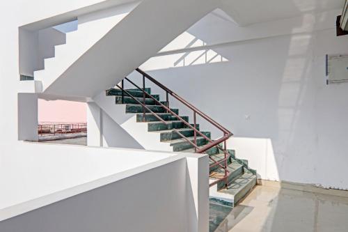 a set of stairs in a white building at Hotel O Fine Stay Guest House in Bhauli