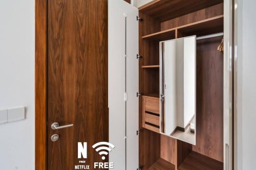 ajar door of a room with a wooden cabinet at Luxury 3Bedroom Condo connected to TRX in Kuala Lumpur