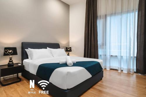 a bedroom with a large bed and a large window at Designer Luxury 3BR Retreat near Pavilion & KLCC in Kuala Lumpur
