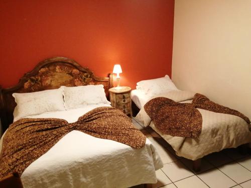 a bedroom with two beds with bows on them at Sol y luna cieneguilla in San Antonio