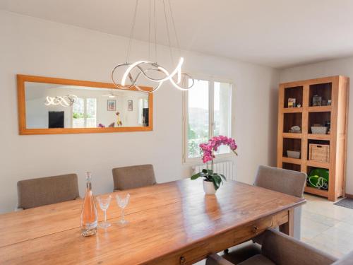 a dining room with a wooden table and a mirror at Belle vue in Le Flayosquet