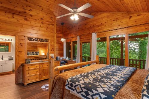 a bedroom with a large bed and a bathroom at Black Bear Cove in Gatlinburg