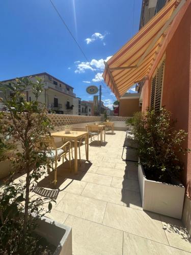 a patio with tables and benches on a building at A Due Passi dal Mare in Catanzaro