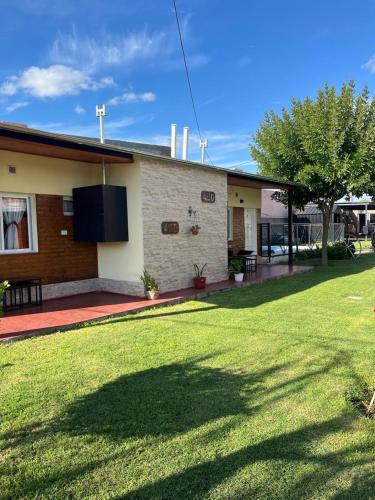 a house with a lawn in front of it at Monoambientes Bajos Medanales in Victorica