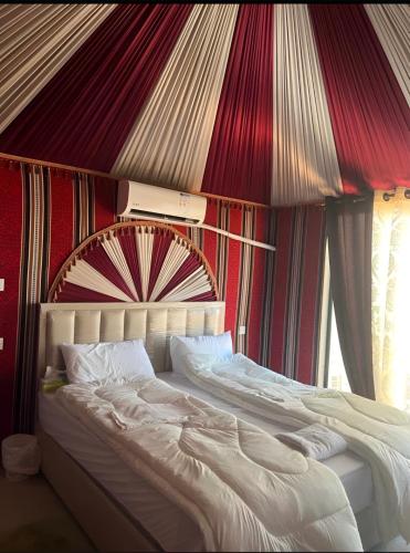 a large bed in a room with a canopy at Rum rose luxury camp in Wadi Rum