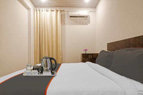 a hotel room with a bed with a blender on it at Super Townhouse RCC Pristine in Hyderabad