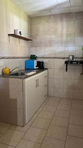 a kitchen with a sink and a counter top at Cabañas bajos medanales in Victorica