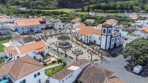 an aerial view of a small town with a church at Green Mountain in Mosteiros