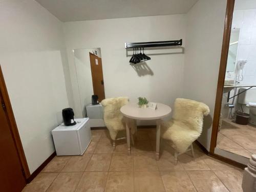 a dining room with a table and chairs in a room at Pousada Flor de Lua Monte Verde in Monte Verde