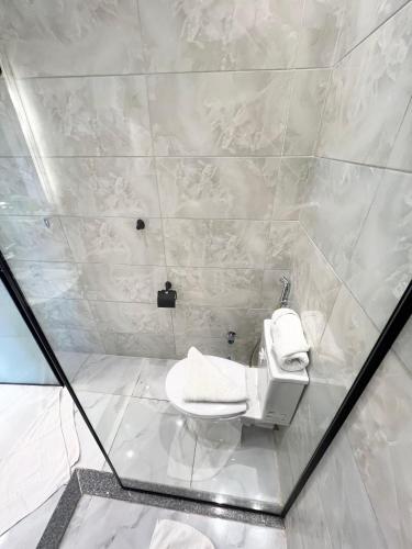a bathroom with a white toilet in a shower at New Jazal pyramids view in Cairo