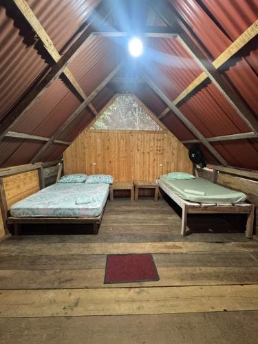 a bedroom in a tent with two beds in it at SURF HOUSE ESTILO LIBRE in Buenaventura