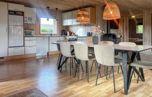 a kitchen with a dining table and chairs at Holiday Home Strandlyst Vinderup I in Vinderup
