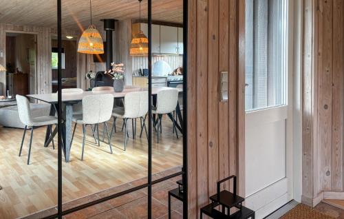 a dining room with a table and chairs at Holiday Home Strandlyst Vinderup I in Vinderup