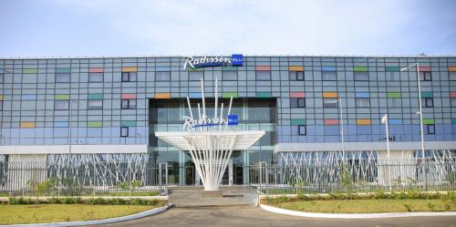 a building with a fountain in front of it at Radisson Blu Hotel, Abidjan Airport in Abidjan
