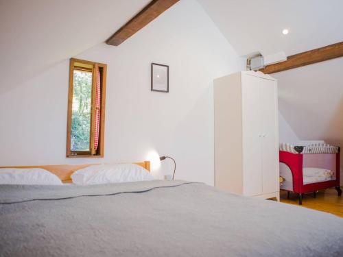 a white bedroom with a bed and a window at Holiday Home MILa - Duplex one bedroom Holiday Home with Terrace in Stubicke Toplice